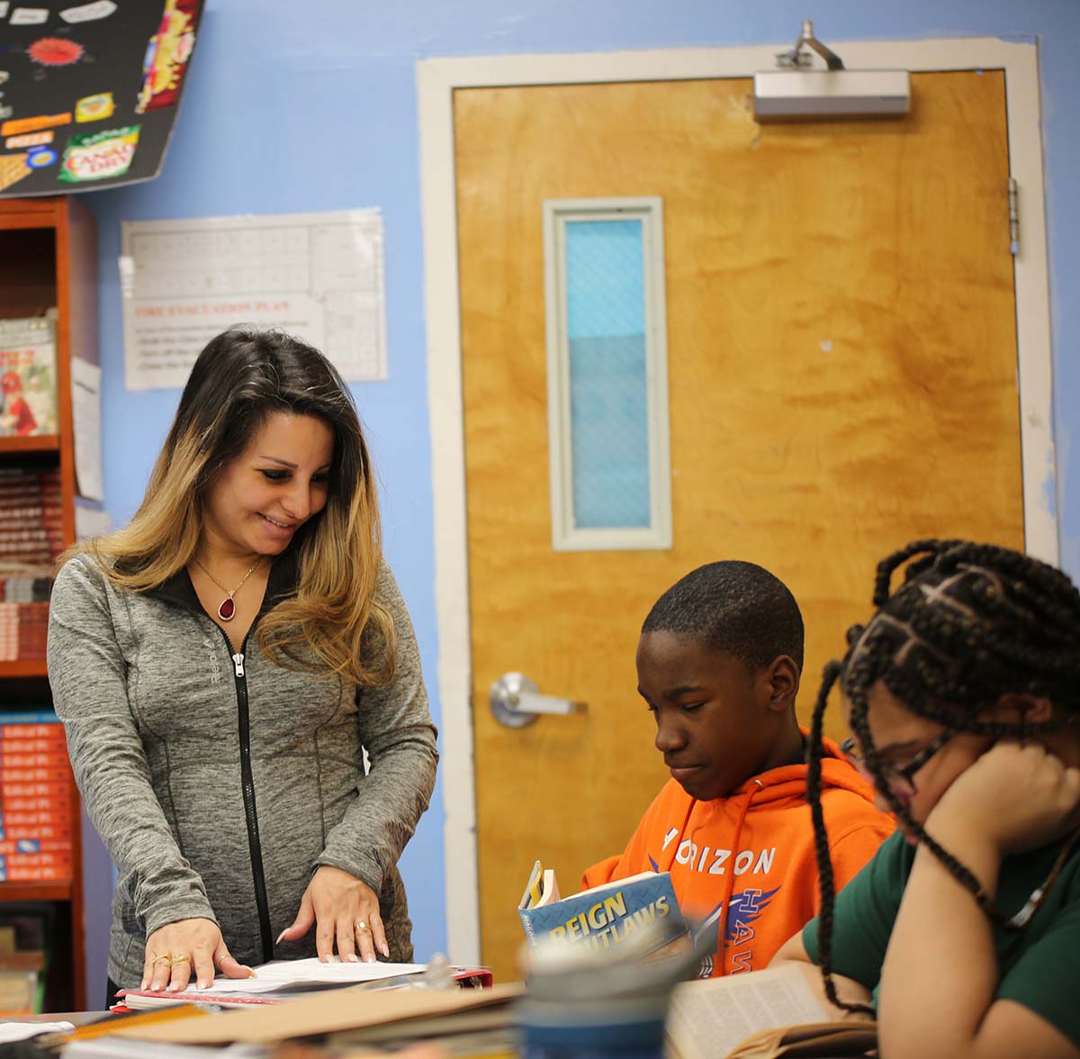 Horizon Science Academy Cleveland Elementary Teacher and student interacting at a classroom desk
